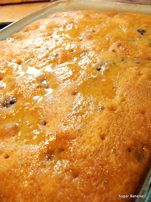 lemon soaking into the lemon soaked berry cake in the baking pan on www.sugarbananas.com