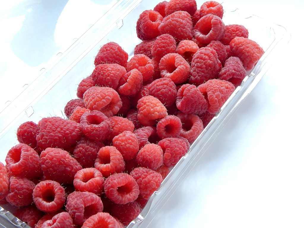 a fresh tray of rinsed and drained raspberries to be added to the batter for raspberry breakfast muffins