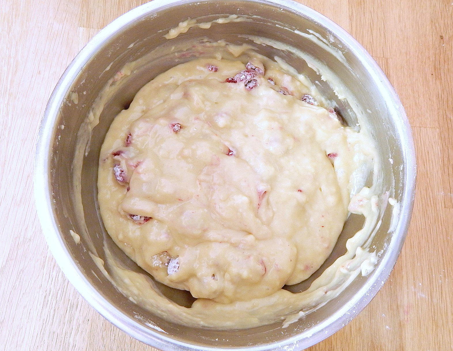 a lumpy mixed batter for raspberry breakfast muffins