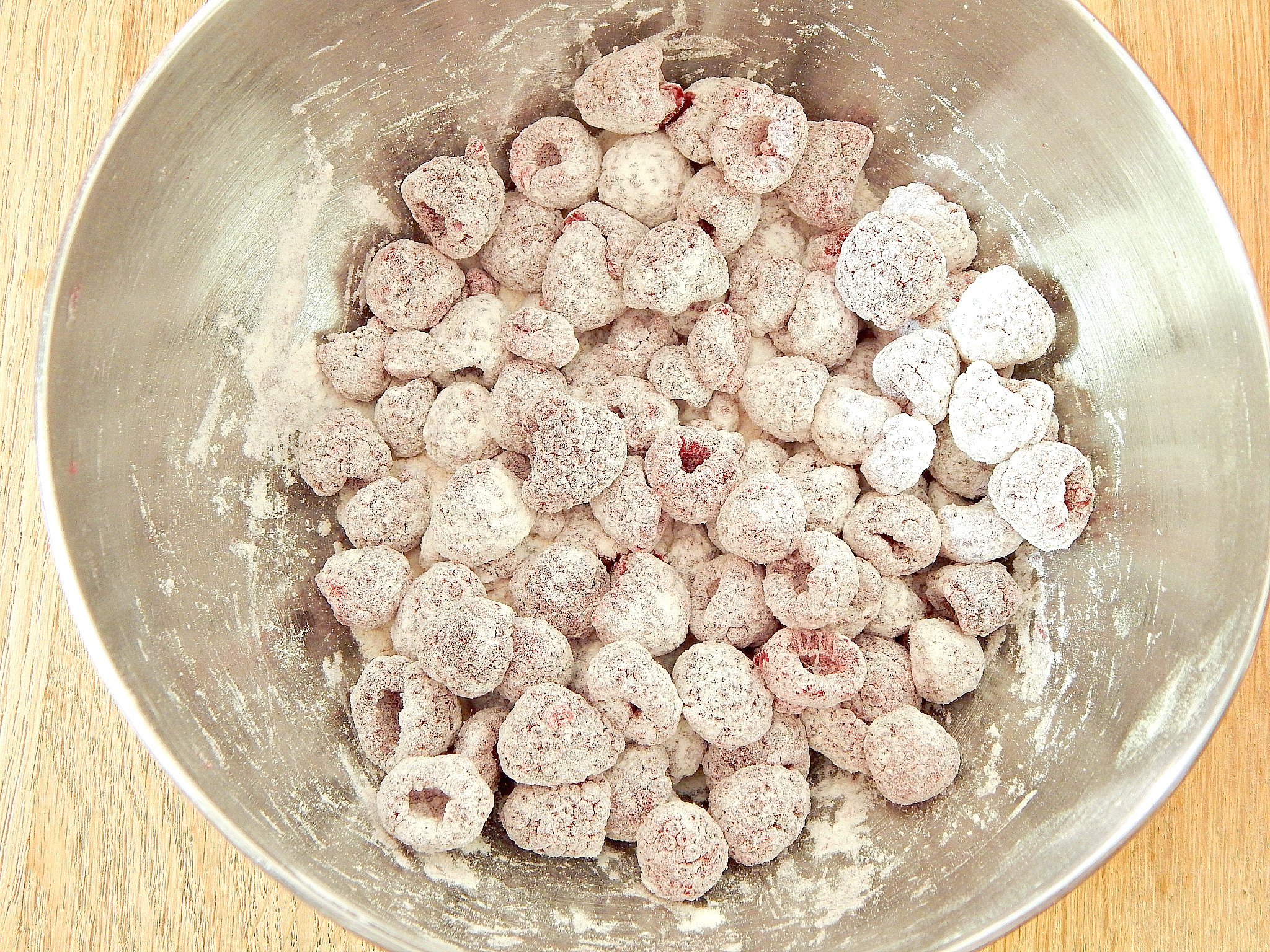 flour dusted raspberries ready to be mixed into batter for raspberry breakfast muffins