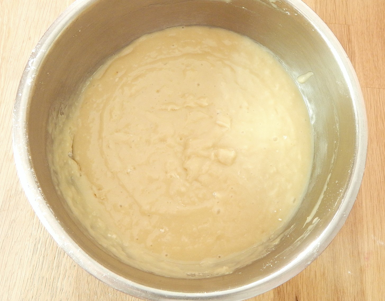 lumpy batter bowl on the counter with batter for raspberry breakfast muffins