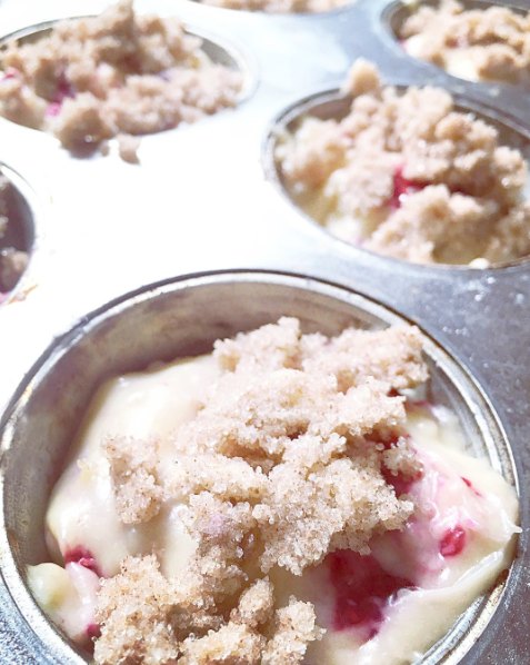 raspberry muffin batter in the muffin tray ready for the oven