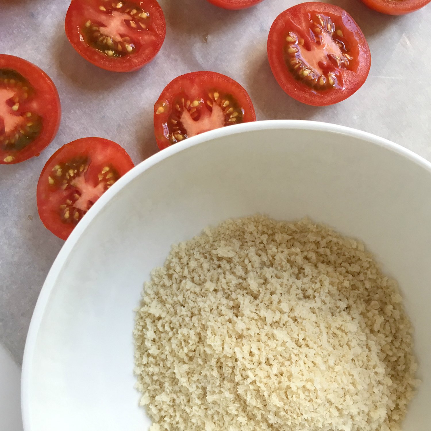 campari tomato halves with panic bread crumb bowl on parchment paper panko parmesan tomatoes