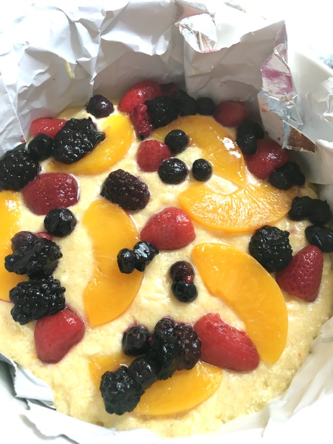 Peach Berry Cornmeal Sheet Cake Batter Topped With Peaches and Berries on www.sugarbananas.com